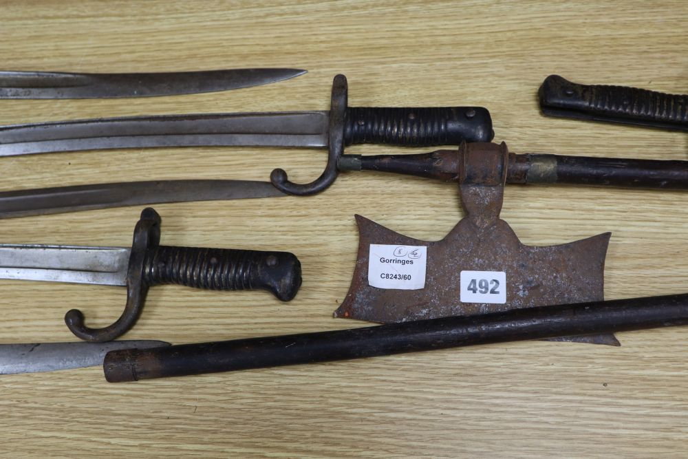 Six bayonets and two axes, largest 99cm